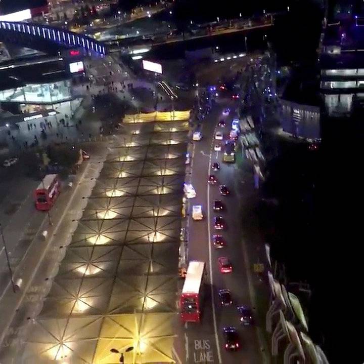 A still image from video shows ambulances and other emergency services response vehicles outside Stratford station in London, Britain