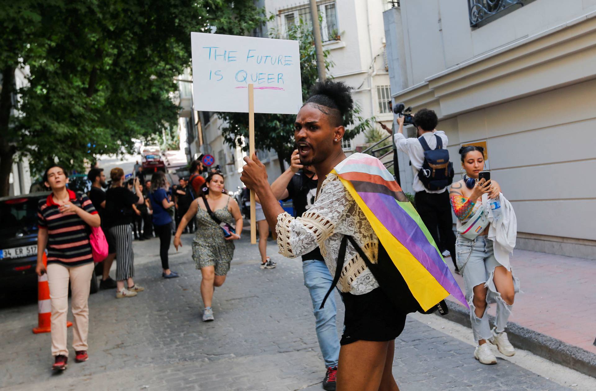 Demonstrators march as they try to gather for a pride parade in Istanbul