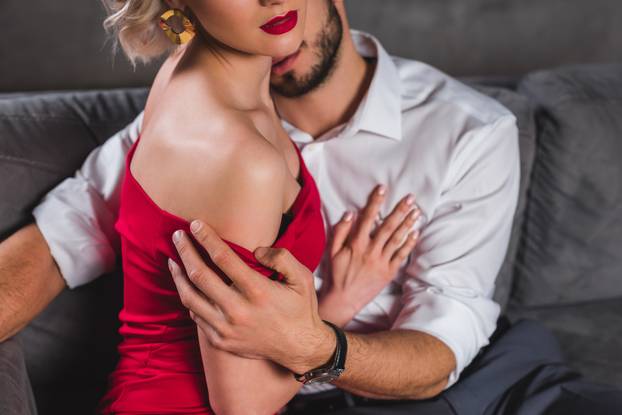 cropped shot of sexy young couple hugging in foreplay