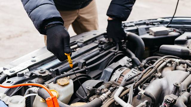 Man,In,Black,Gloves,Checking,The,Oil,Level,In,A