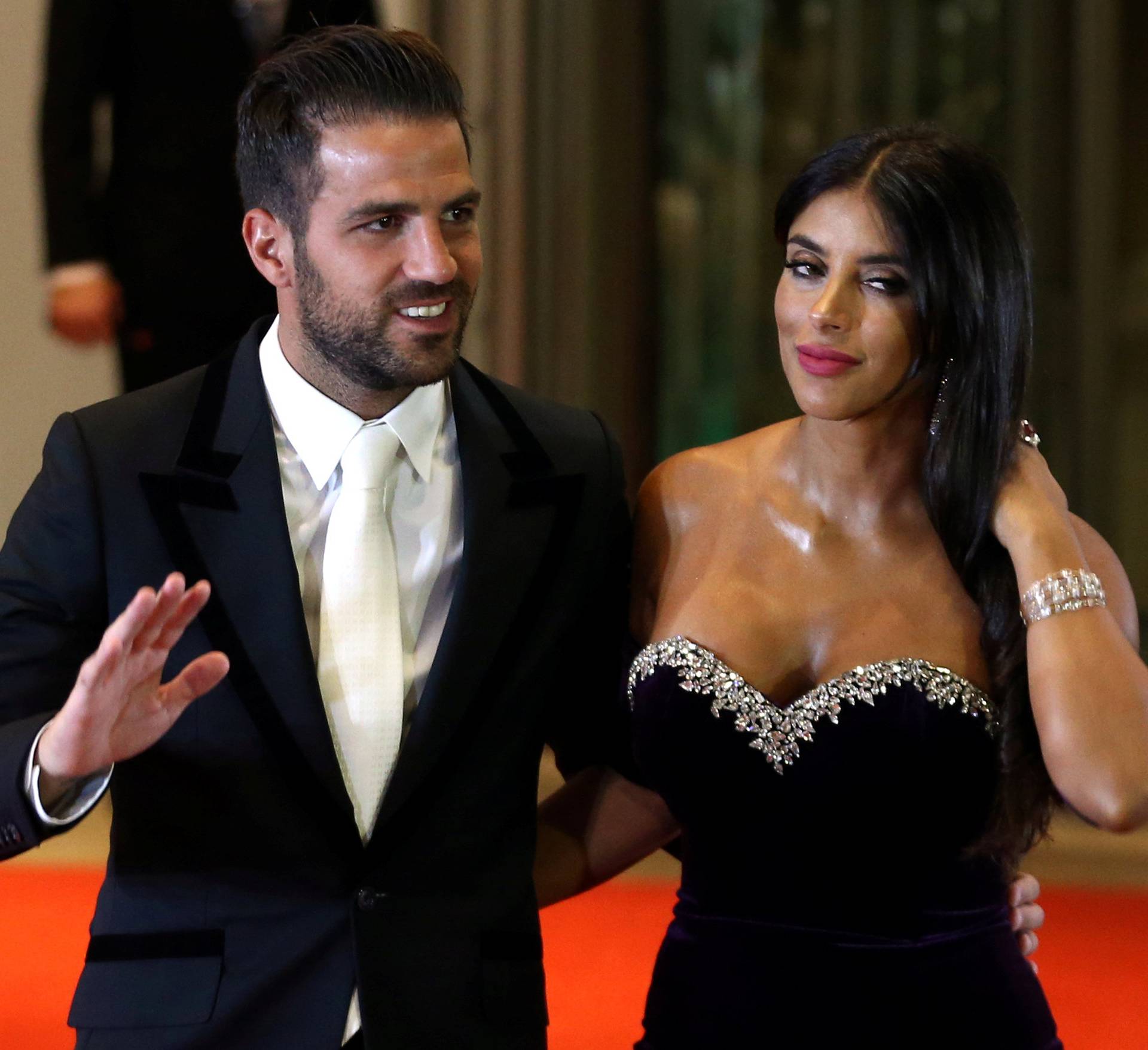 Argentine soccer player Lionel Messi's former Barcelona FC teammate Cesc Fabregas and his wife Daniella Semaan pose for photographers as they arrive to the wedding of Messi and Antonela Roccuzzo in Rosario