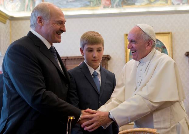 Pope Francis is greeted by Belarussian President Alexander Lukashenko and his son Nikolai during a private audience at the Vatican