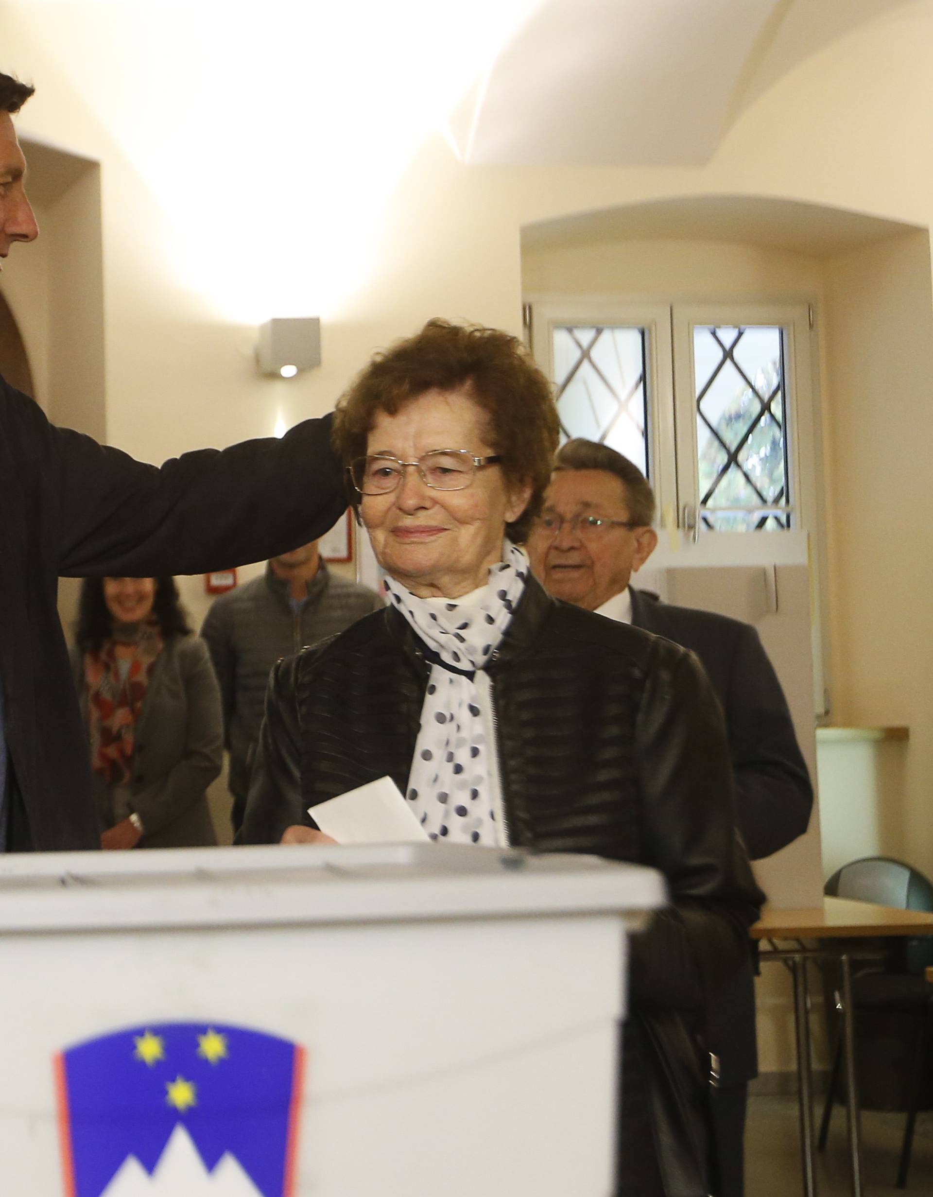 Presidential candidate Borut Pahor and his mother Ivica Martelanc cast their votes at a polling station during the presidential election in Sempeter pri Novi Gorici