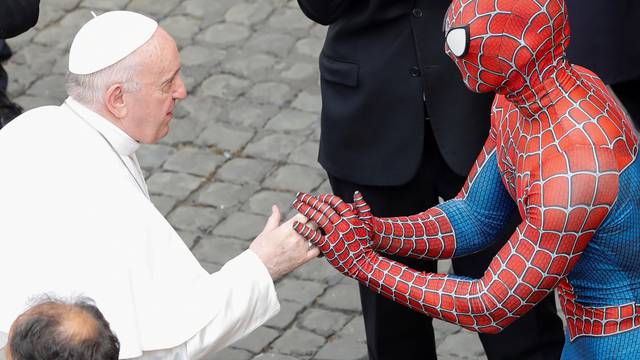 Pope Francis greets a person dressed as Spiderman, at the Vatican