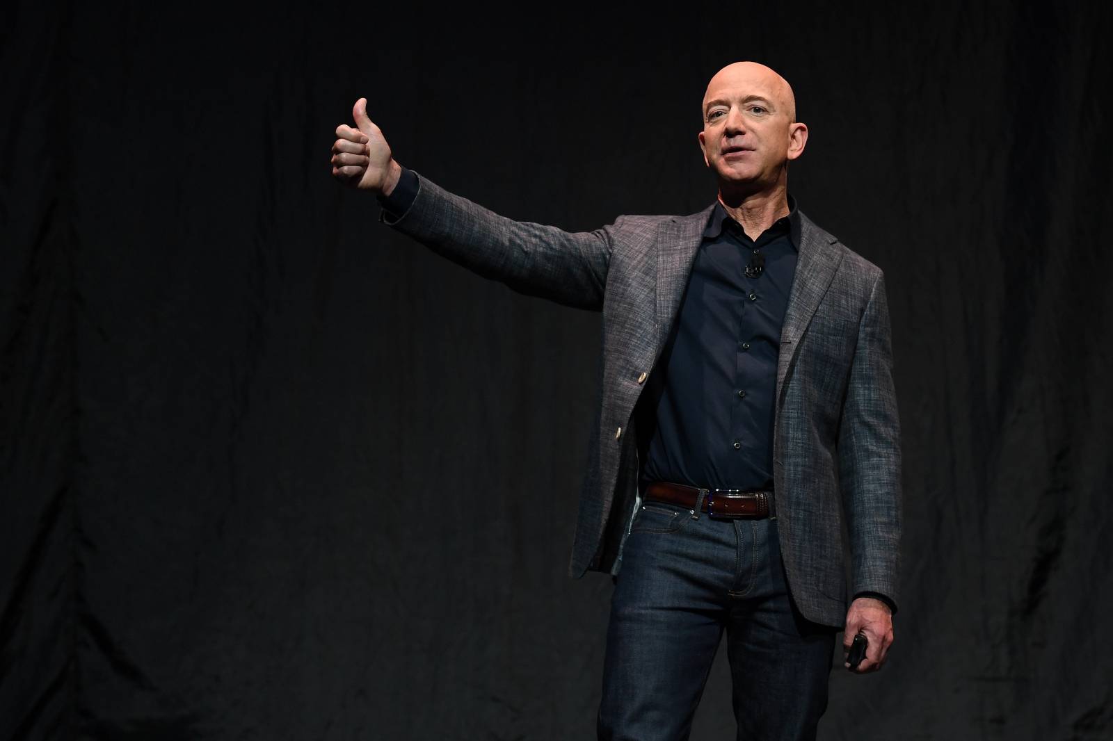 Founder, Chairman, CEO and President of Amazon Jeff Bezos gives a thumbs up as he speaks during an event about Blue Origin's space exploration plans in Washington