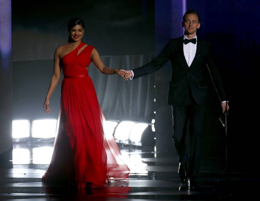Actors Chopra and Hiddleston walk onstage to present an award at the 68th Primetime Emmy Awards in Los Angeles