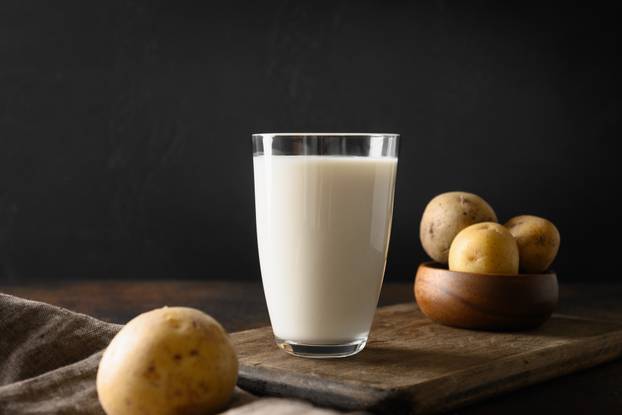 Vegan potato milk in glass, plant based milk replacer.