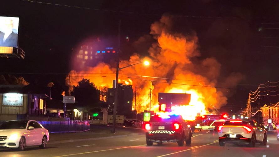 Smoke and flames rise from the site of a burning building, in Denver