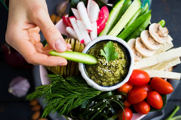 Woman,Hands,Puts,Cucumber,To,Healthy,Veggie,Buddha,Bowl,With