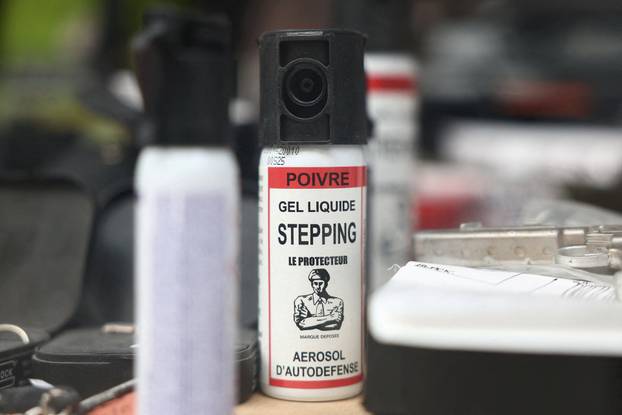 FILE PHOTO: Pepper spray canisters on display in the window of a gun shop in Paris