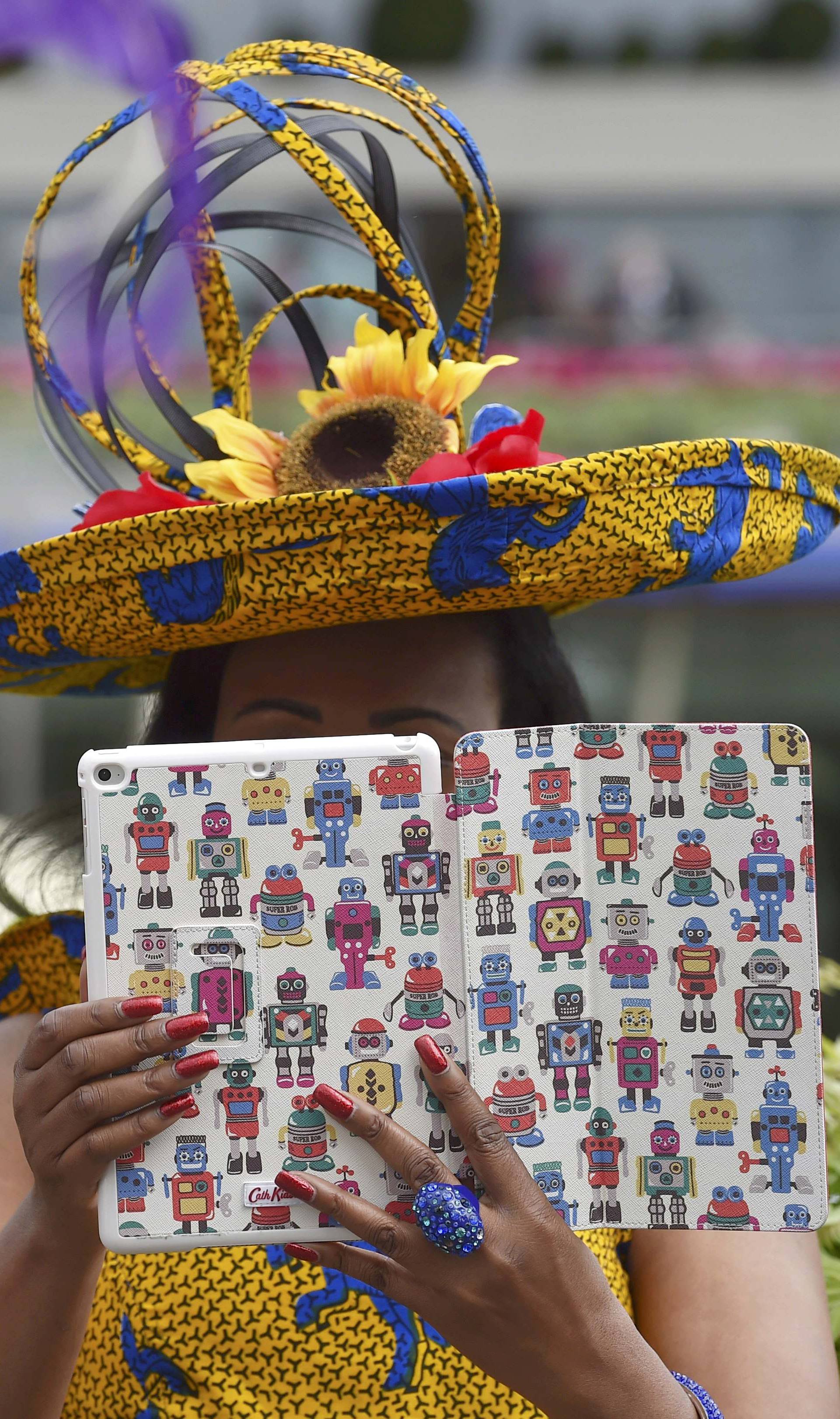 Britain Horse Racing Ladies Day Racegoer uses tablet to take picture