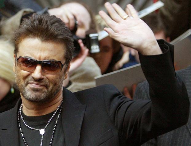 FILE PHOTO: British singer and actor George Michael waves as he leaves a news conference to introduce the film 'George Michael: A Different Story'  in Berlin