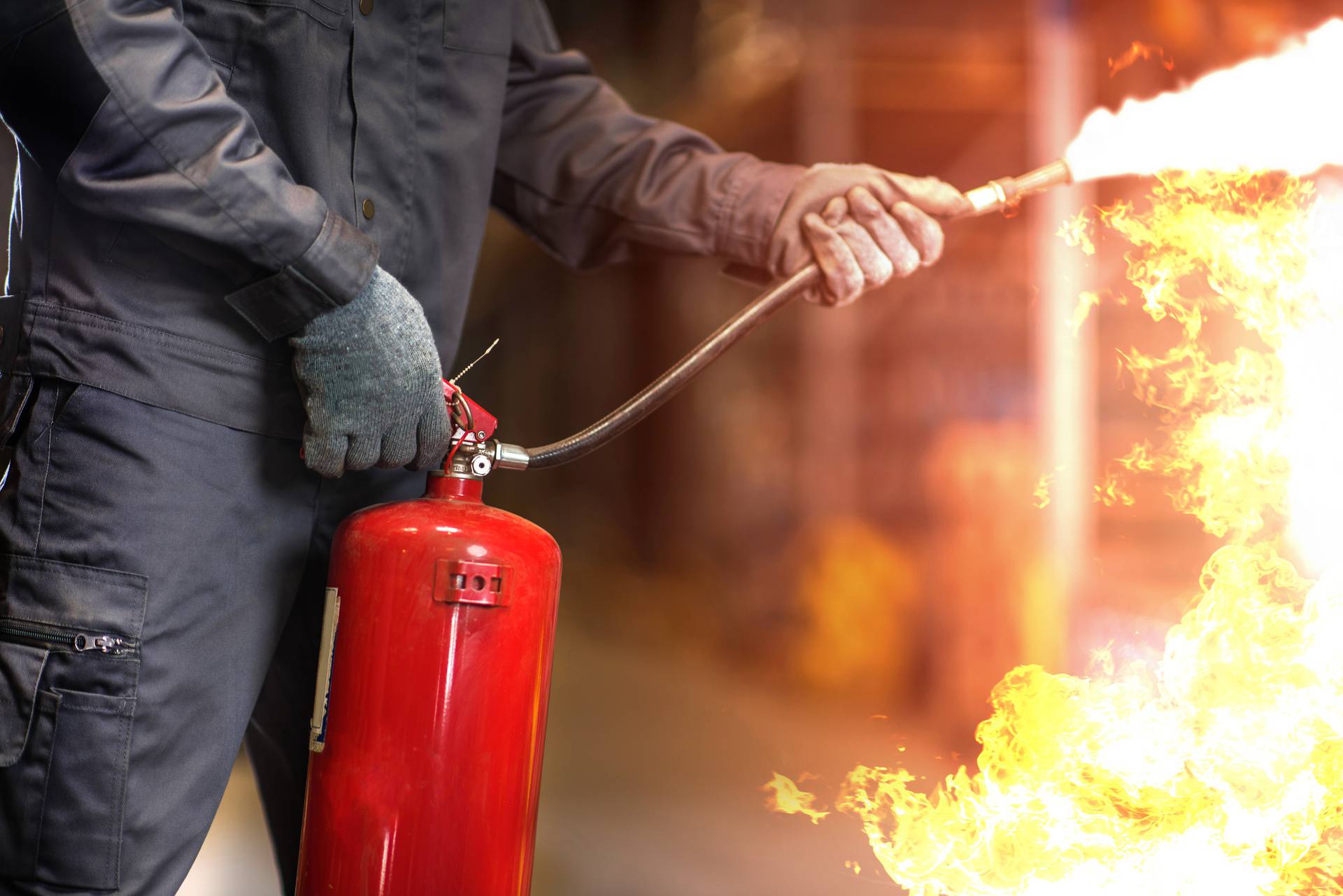 Man,Using,Fire,Extinguisher,Fighting,Fire,Closeup,Photo.