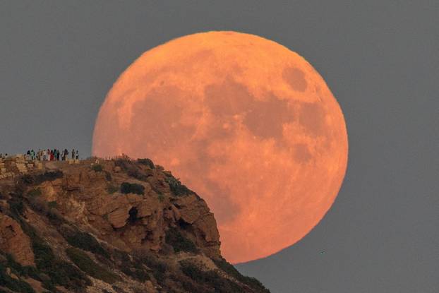 Full moon rises behind the Temple of Poseidon in Cape Sounion