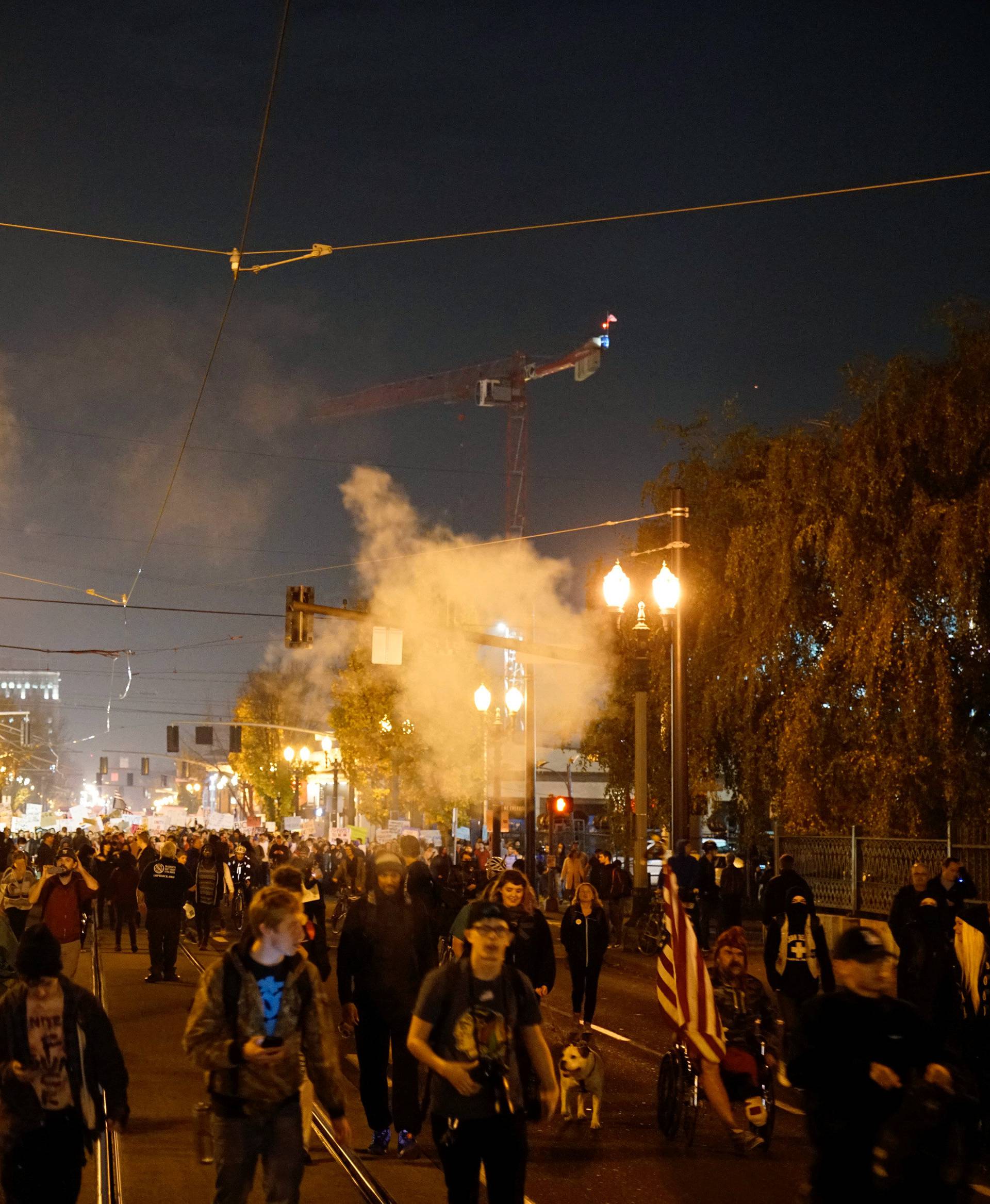 Smoke rises during a protest against the election of Republican Donald Trump as President of the United States in Portland, Oregon