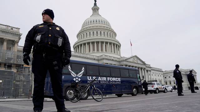 Air Force bus meant to transport Speaker of the House Pelosi and other members of Congress to flight to Afghanistan sits in front of Capitol in Washington