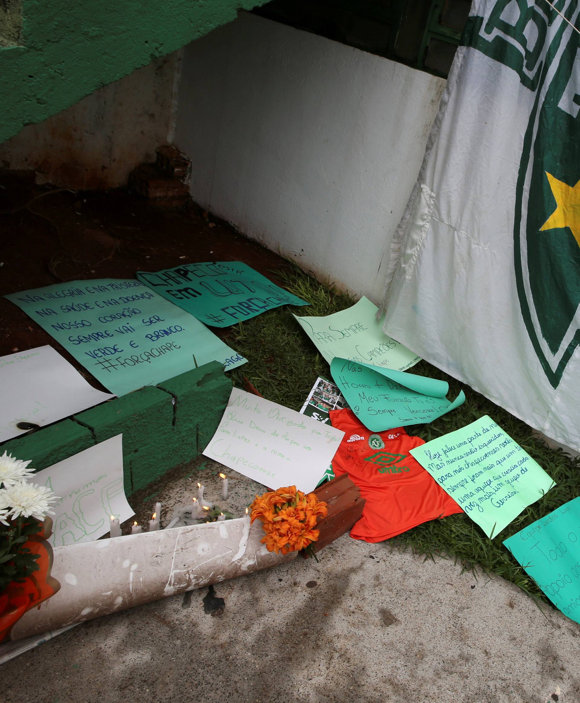 Flowers and messages are seen next a Chapecoense soccer team flag in tribute to their players in front of the Arena Conda stadium in Chapeco