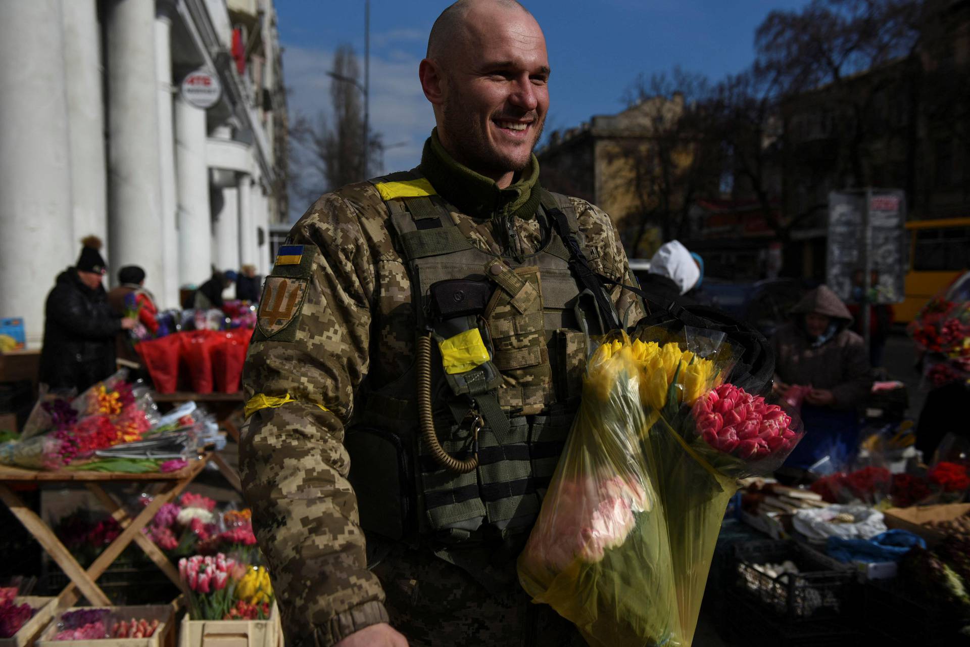 Ukrainian soldier Dmitriy, 32, buys flowers at a street market, amid Russia's invasion of Ukraine, in Odessa