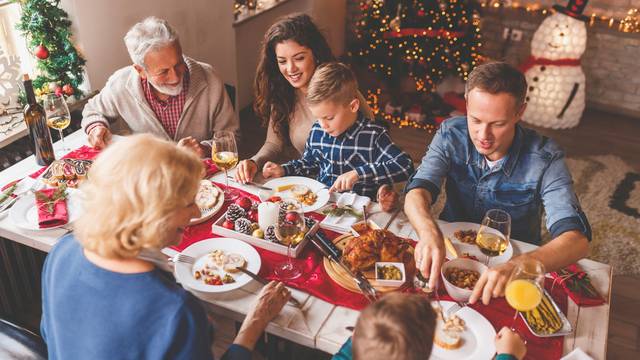 High,Angle,View,Of,Happy,Family,Gathered,Around,The,Table,