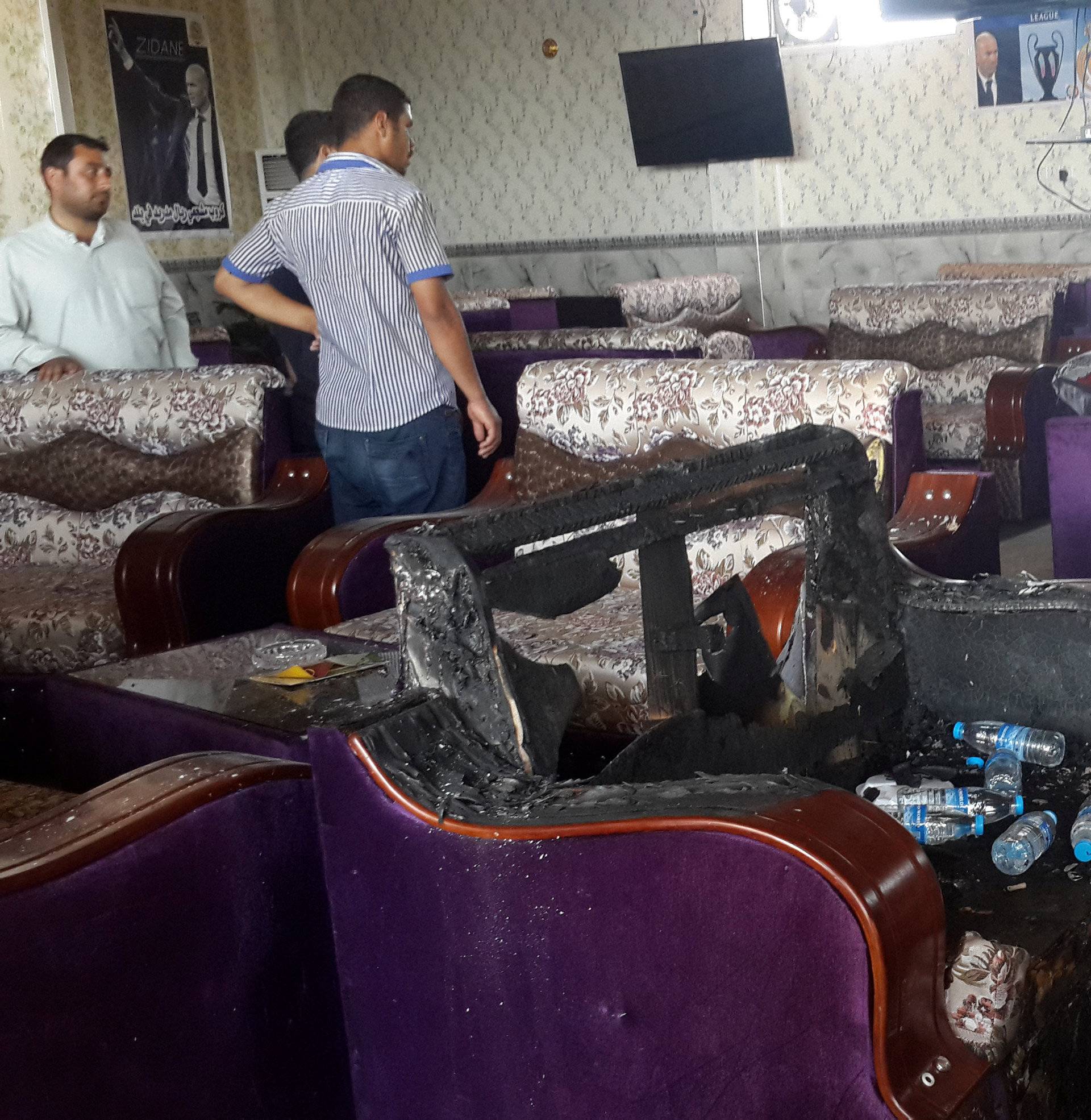 People gather at a cafe after an attack in the predominately Shi'ite Muslim town of Balad