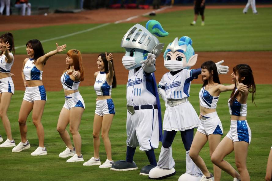 Mascots of a baseball team dance while wearing face masks at the first professional league game that allow audience since the outbreak of the coronavirus disease (COVID-19) in Taipei