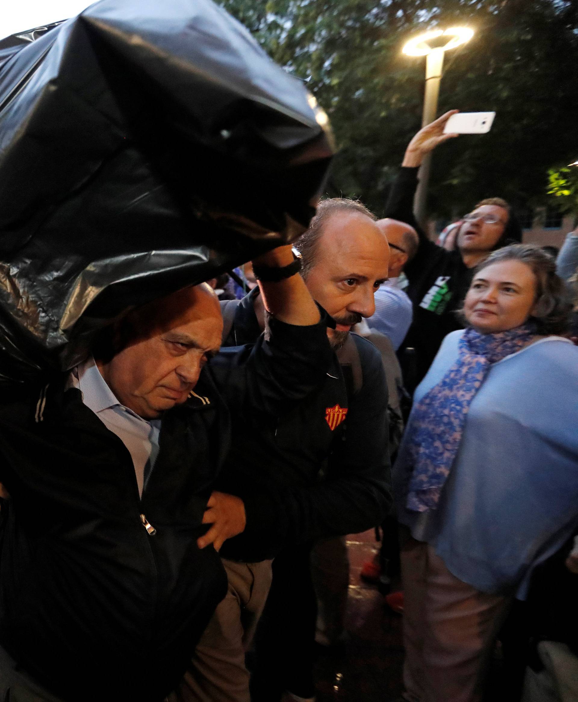 A  man holds ballots at a polling station for the banned independence referendum in Barcelona