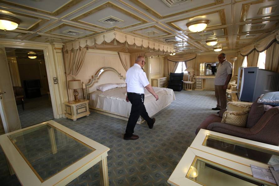 A captain walks inside the yacht called "Basrah Breeze", once owned by former Iraqi president Saddam Hussein, who was toppled in a U.S.-led invasion in 2003, in the southern port of Basra