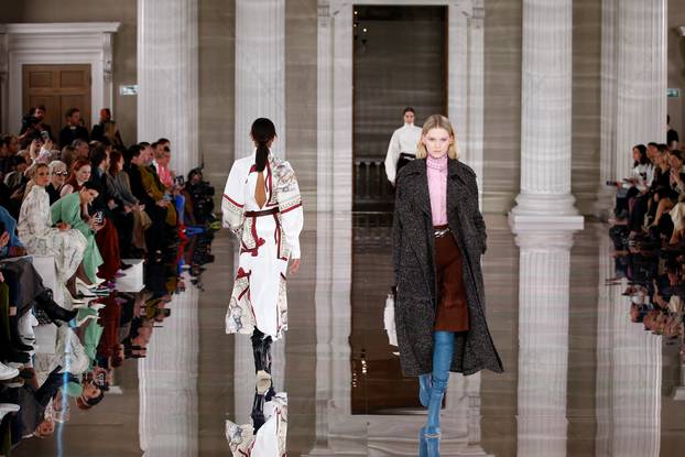 Models present creations at the Victoria Beckham catwalk show during London Fashion Week in London