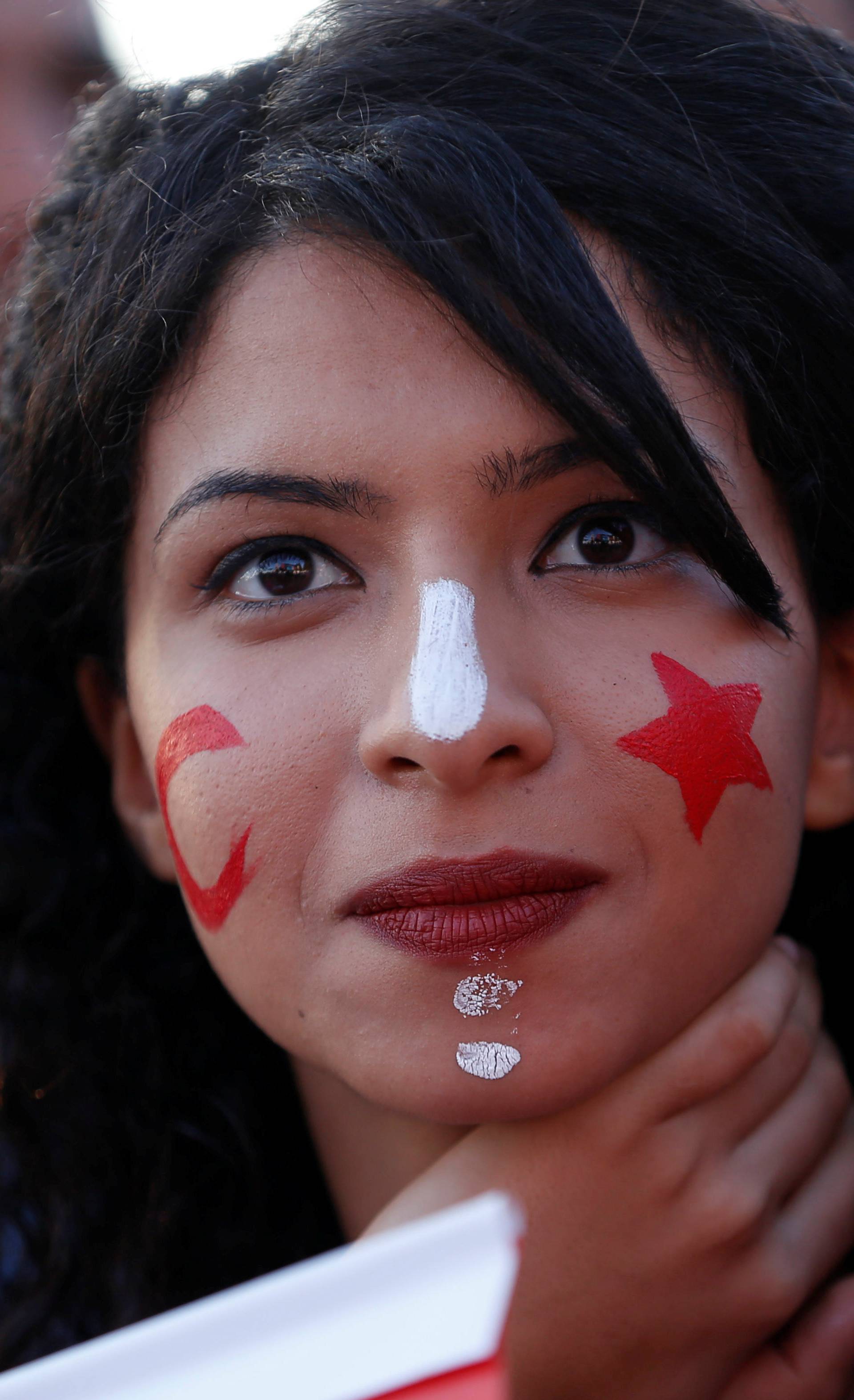 Fans react as they watch the broadcast of the FIFA World Cup Group G soccer match between Tunisia and England, in Tunis