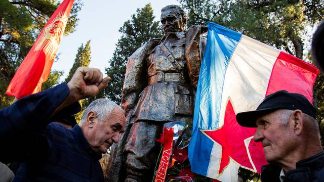People crowd for a picture at the monument of late Yugoslav leader Josip Broz Tito after unveiling ceremony in Podgorica