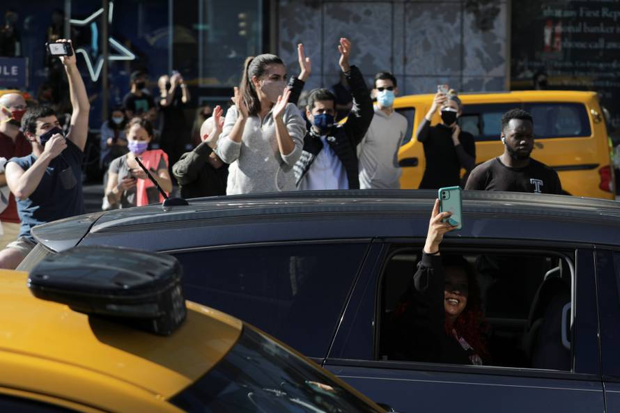 People celebrate media announcing that Democratic U.S. presidential nominee Joe Biden has won the 2020 U.S. presidential election