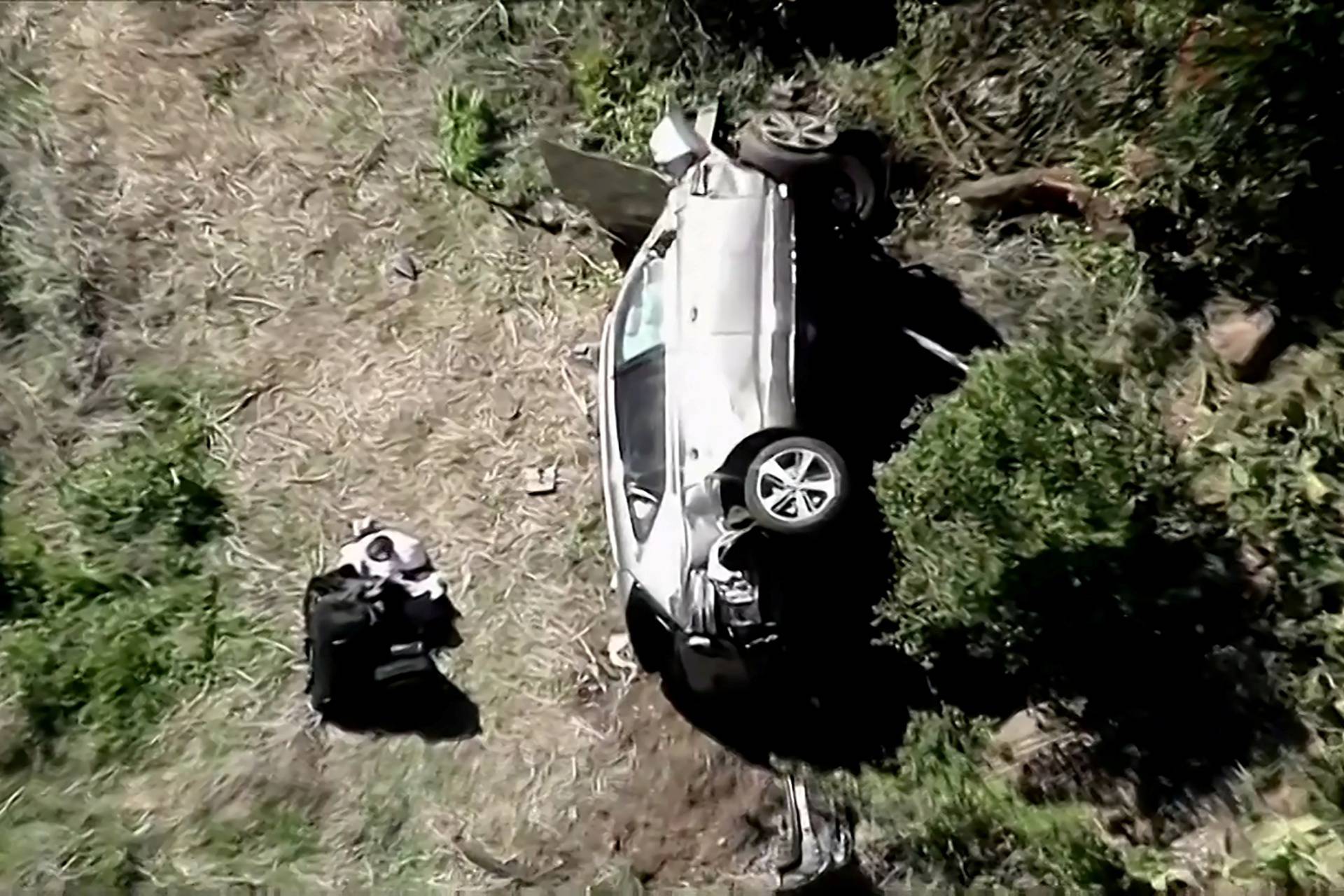 The vehicle of golfer Tiger Woods lies on its side after being involved in a single-vehicle accident in Los Angeles