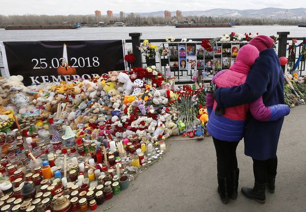 FILE PHOTO: People visit a makeshift memorial on the day of national mourning for the victims of a Kemerovo shopping mall fire in Krasnoyarsk