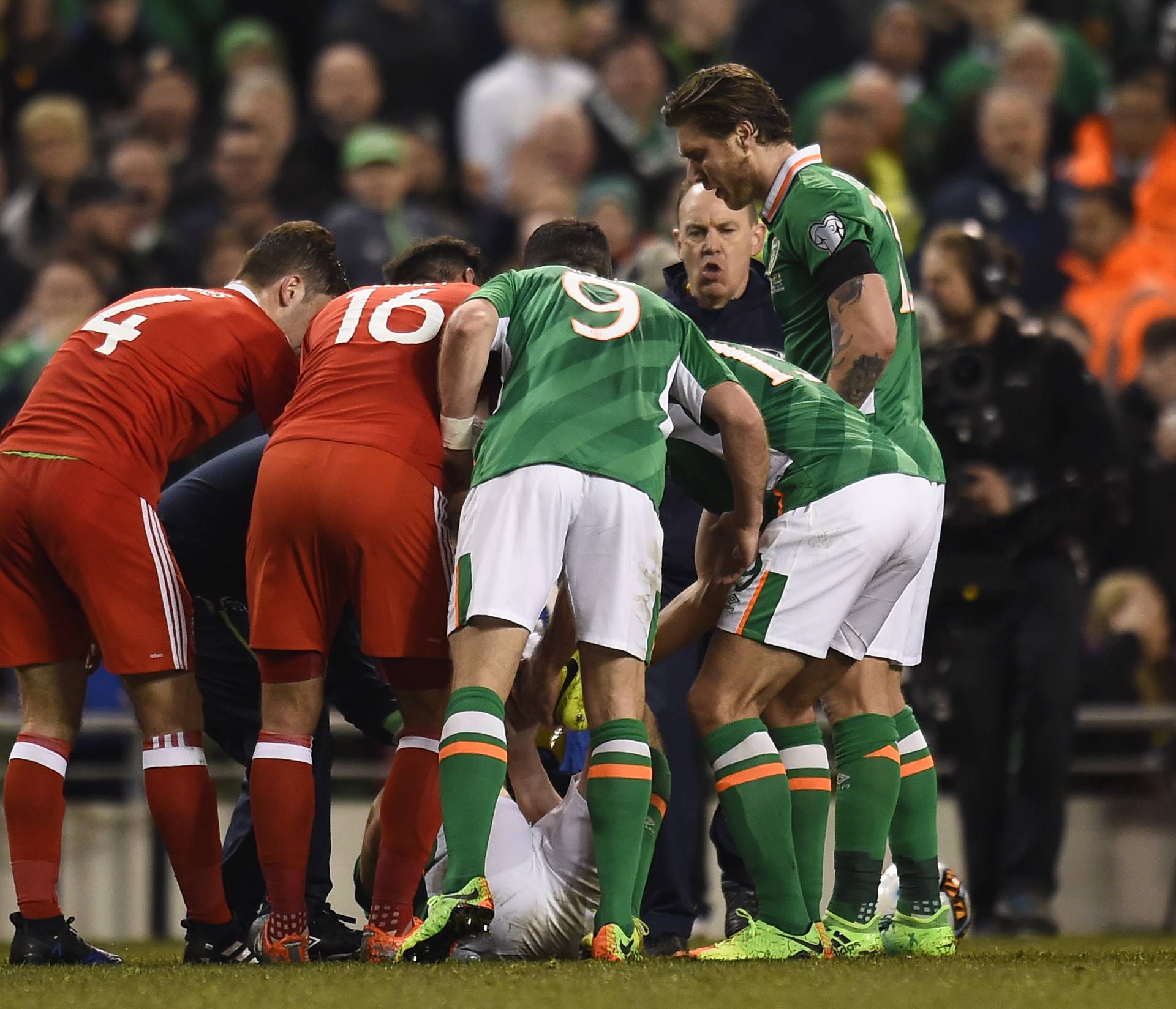 Players surround Republic of Ireland's Seamus Coleman as he lies injured