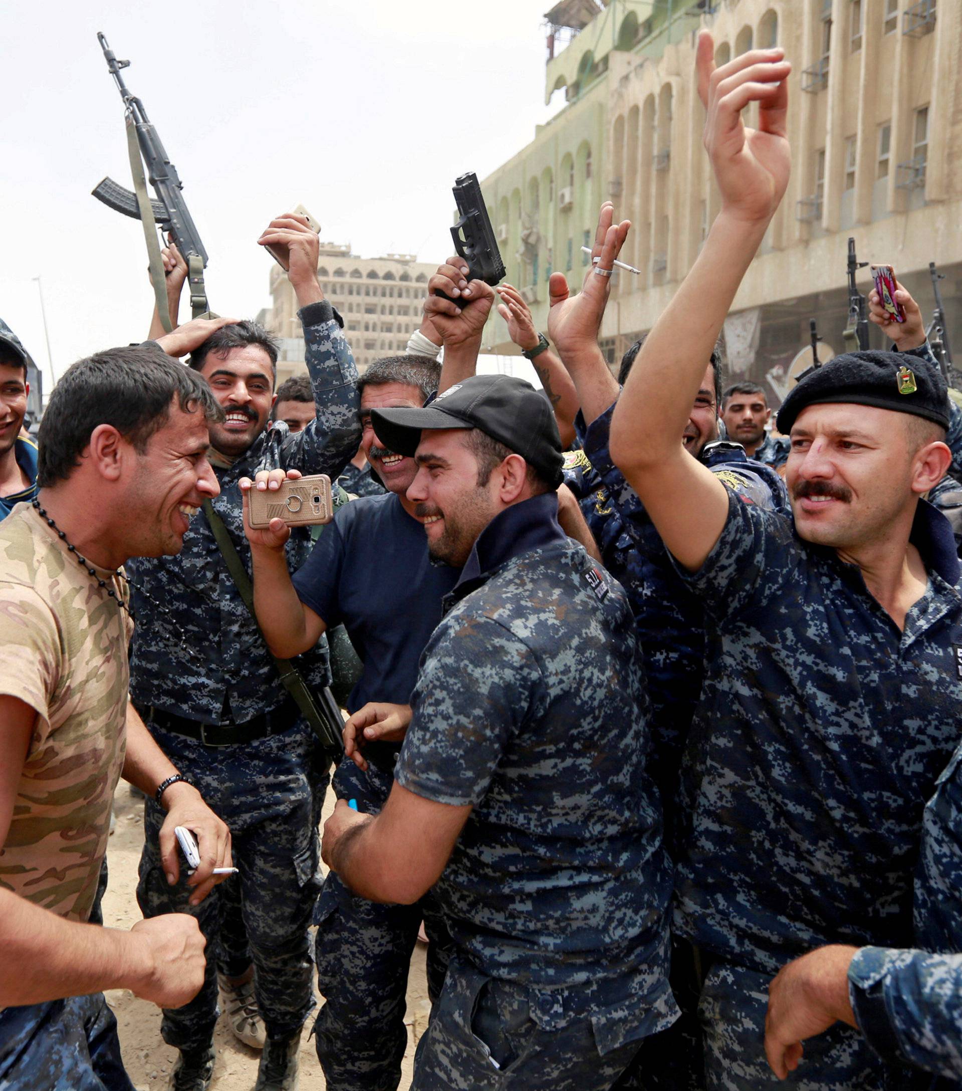 Iraqi Federal police celebrate in the Old City of Mosul