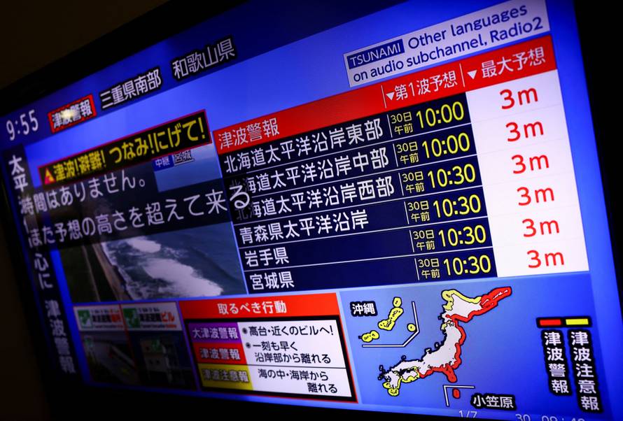 A television screen shows a news report on the tsunami warning after a powerful earthquake struck off Russia's Far Eastern Kamchatka Peninsula, in Tokyo