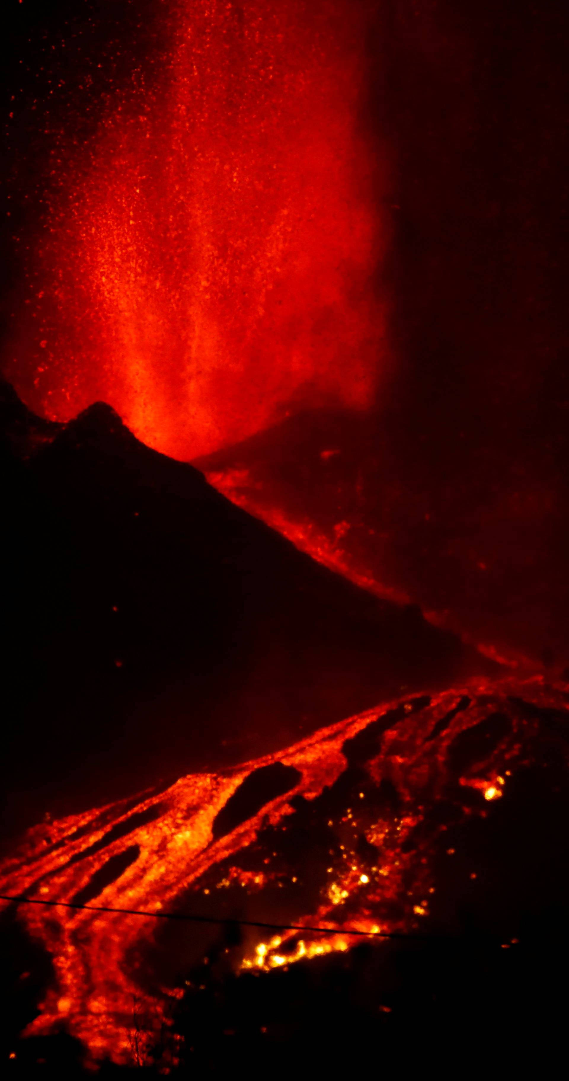 Lava flows downhill following the eruption of a volcano in Spain