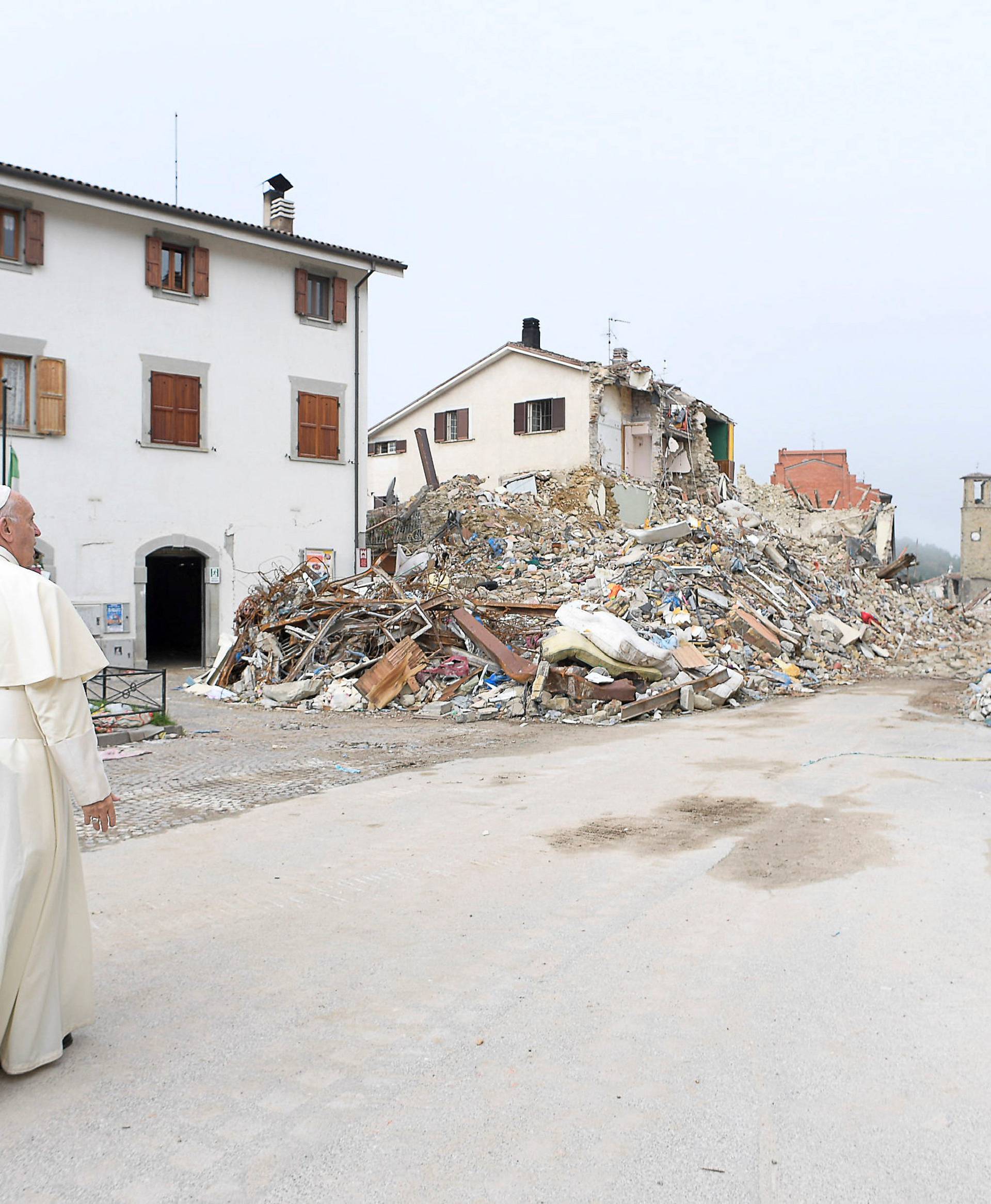 Pope Francis talks with a firefighter in Amatrice