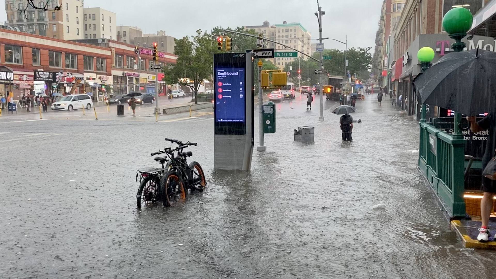 A person wades through the flood water near the 157th St. metro station in New York