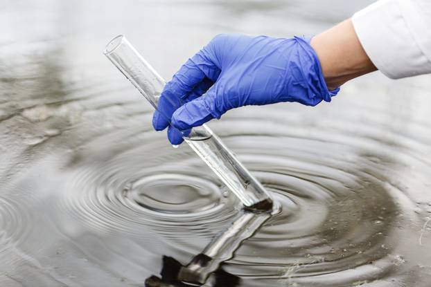 Researcher,Holds,A,Test,Tube,With,Water,In,A,Hand