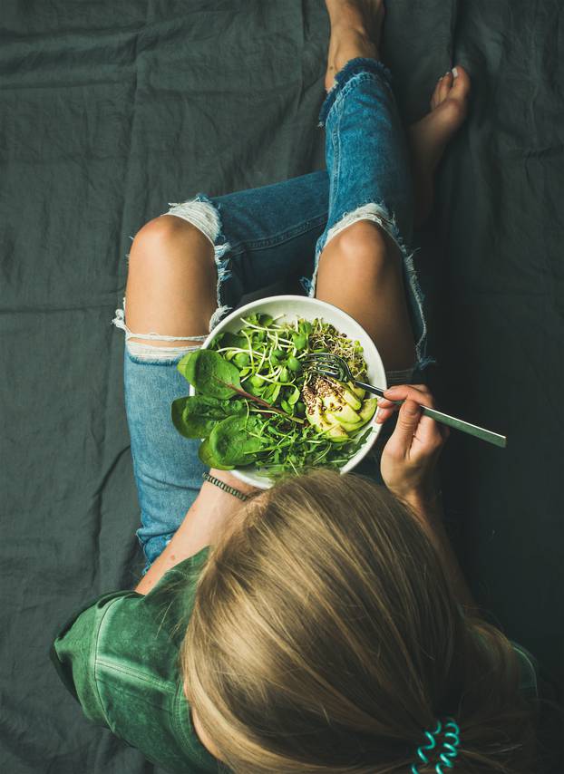 Vegetarian breakfast meal with spinach, arugula, avocado, seeds and sprouts