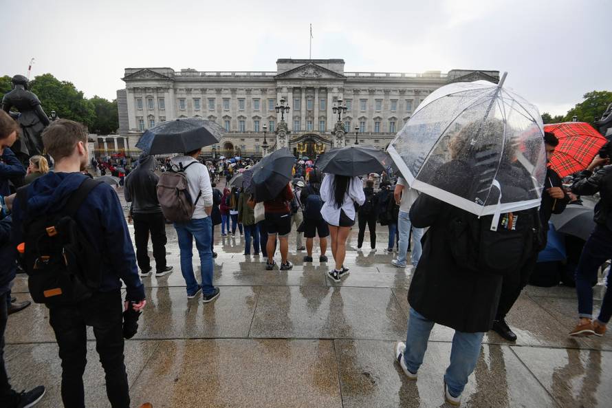 People gather outside Buckingham Palace in London