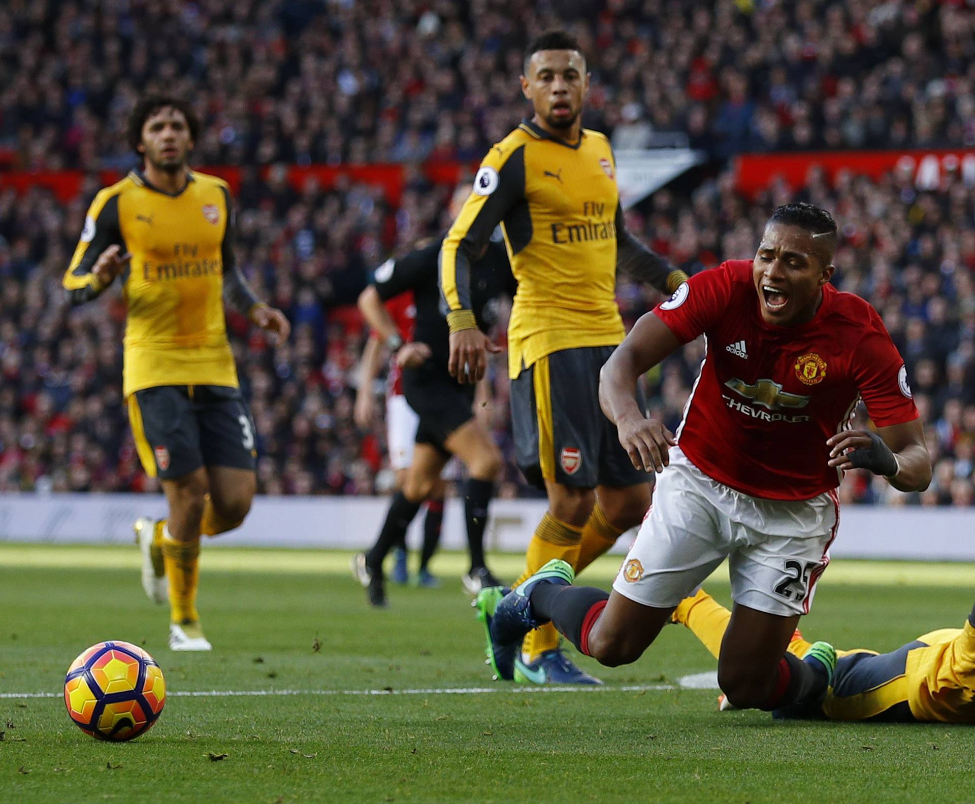 Manchester United's Antonio Valencia goes down in the area after a challenge by Arsenal's Nacho Monreal however a penalty is not awarded