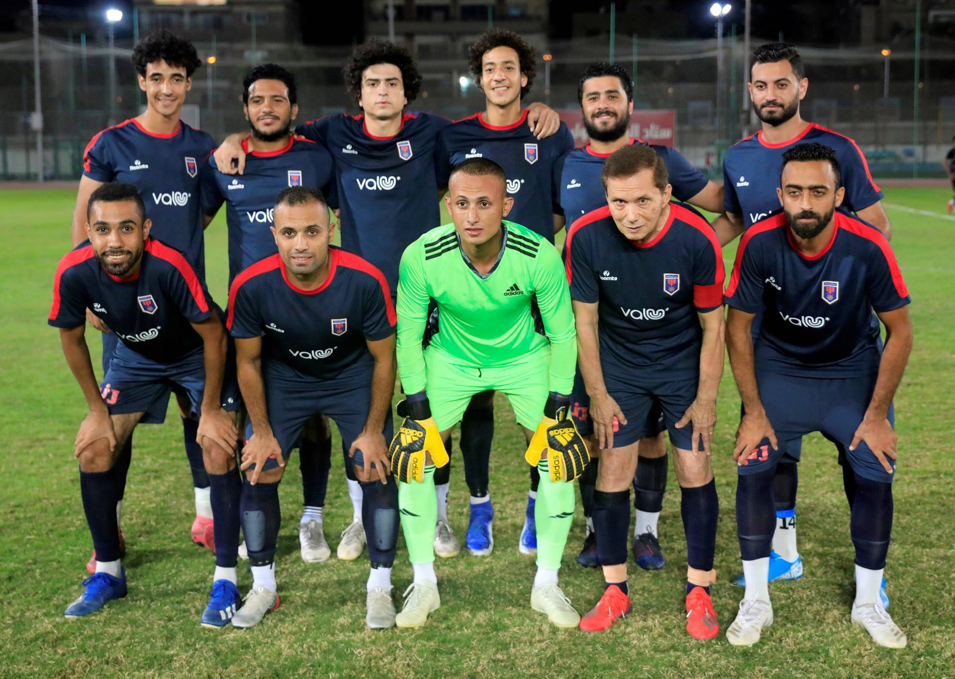 Ezzeldin Bahader (2nd R), a 74-years-old Egyptian football player of 6th October Club poses for a team group photo before a soccer match against El Ayat Sports Club of Egypt's third division league at the Olympic Stadium in the Cairo suburb of Maadi