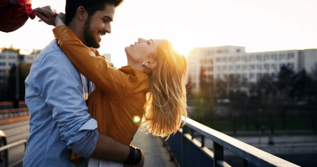 young couple hugging dating and kissing outdoor