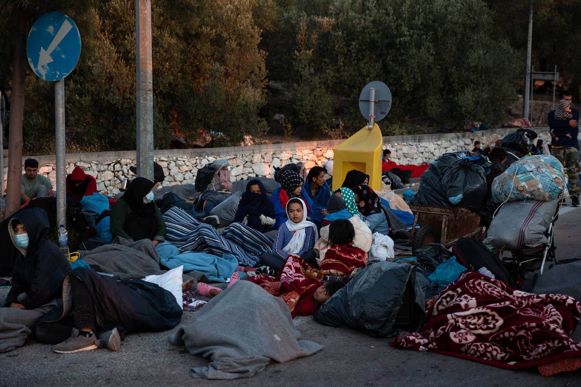 Refugees and migrants camp on a road following a fire at the Moria camp on the island of Lesbos