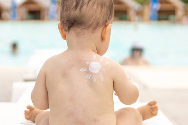 Baby,Sitting,On,White,Beach,Chair,With,Sun,Shape,From