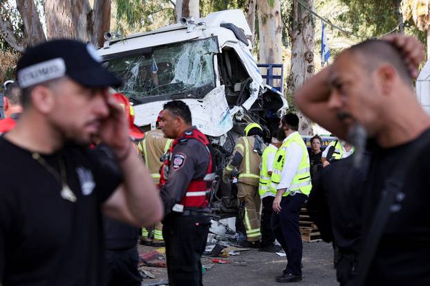 Israeli emergency services work at the scene where a truck rammed into pedestrians at a bus stop, in Ramat Hasharon