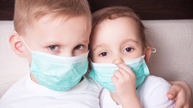 Boy and girl, a children in a medical mask. The concept of an epidemic, influenza, protection from disease, vaccination.