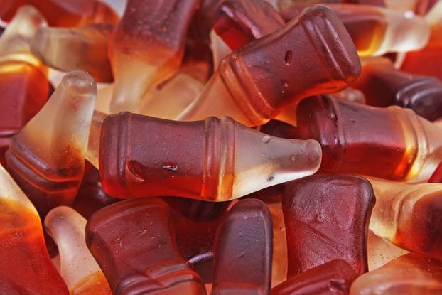 Cola gum candy. Gummy candy cola flavored sweet snack. Cola bottle shaped sweets.